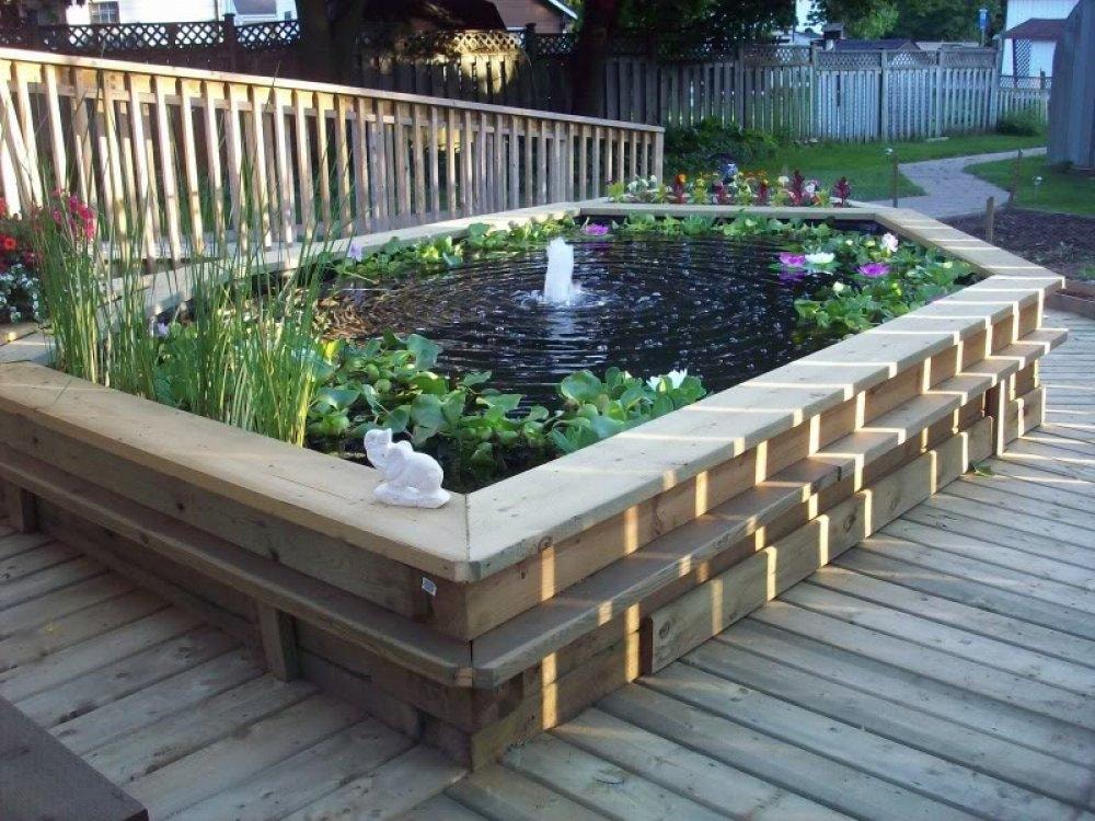 Above-ground pond with wooden deck surround and water lilies
